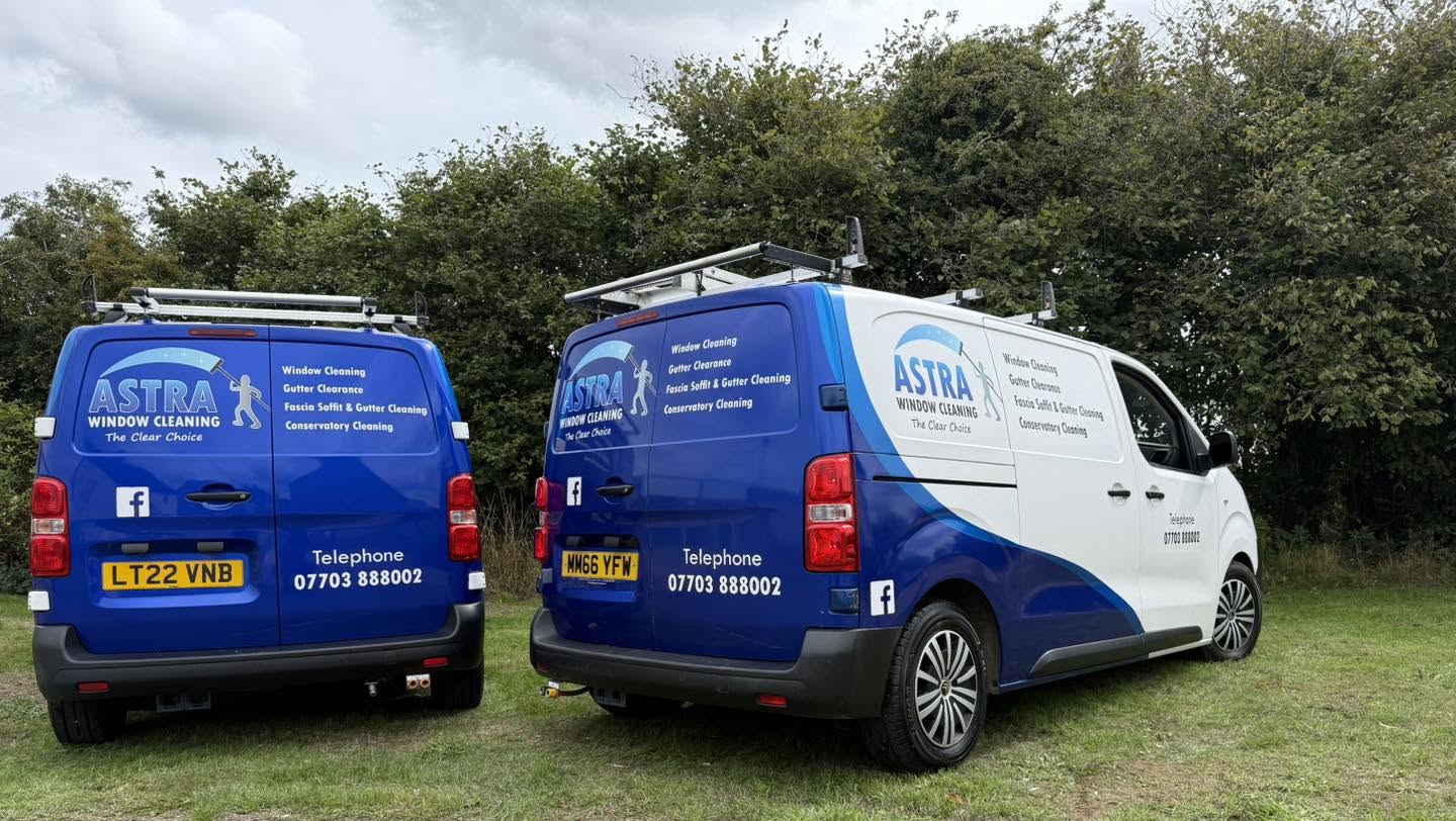 The back of the two Astra vans showing the services and phone number